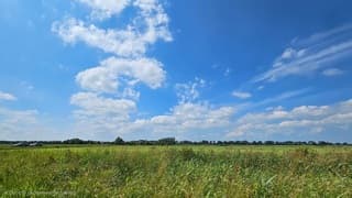 Warme zomerdag boven Friese landschap