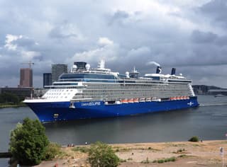 cruisescheepje vertrekkend uit bewolkt Amsterdam