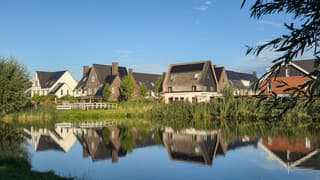 Rustige zondagmorgen met weerschijn huizen in water