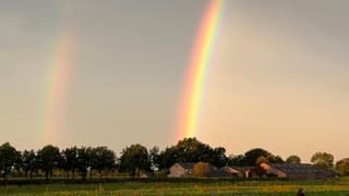 Dubbele regenboog bij zonsopkomst 