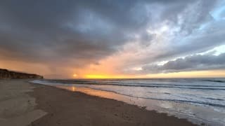 Zonsondergang en bui op zee