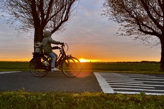 Op de fiets naar school met zonsopkomst