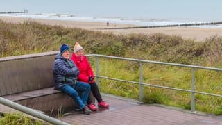 Tussen de miezerbuitjes op een bankje