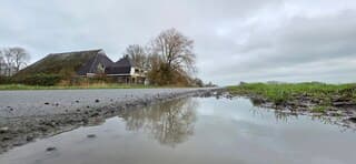 Bewolking en weerspiegeling in een regenplas vanmiddag 