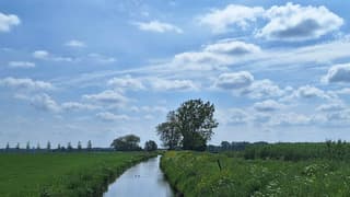 zonnig, blauwe lucht en wolkjes