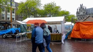 Onder de paraplu voor af en toe bui, natte curiosamarkt